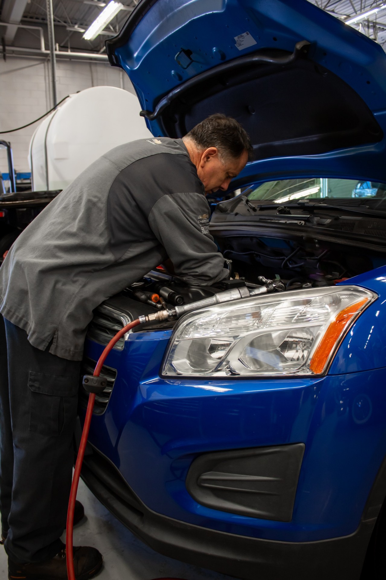 Patriot Chevrolet certified technician performing a service under the hood