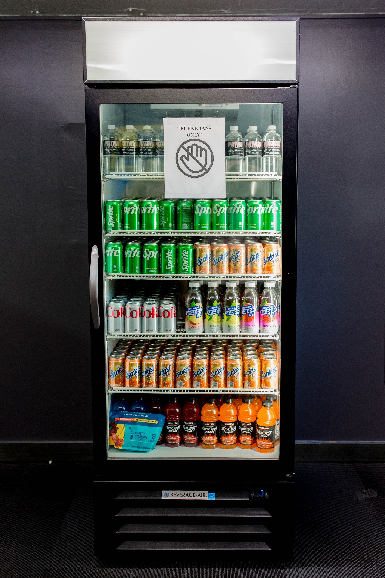 Technician-only stocked fridge with drinks and snacks