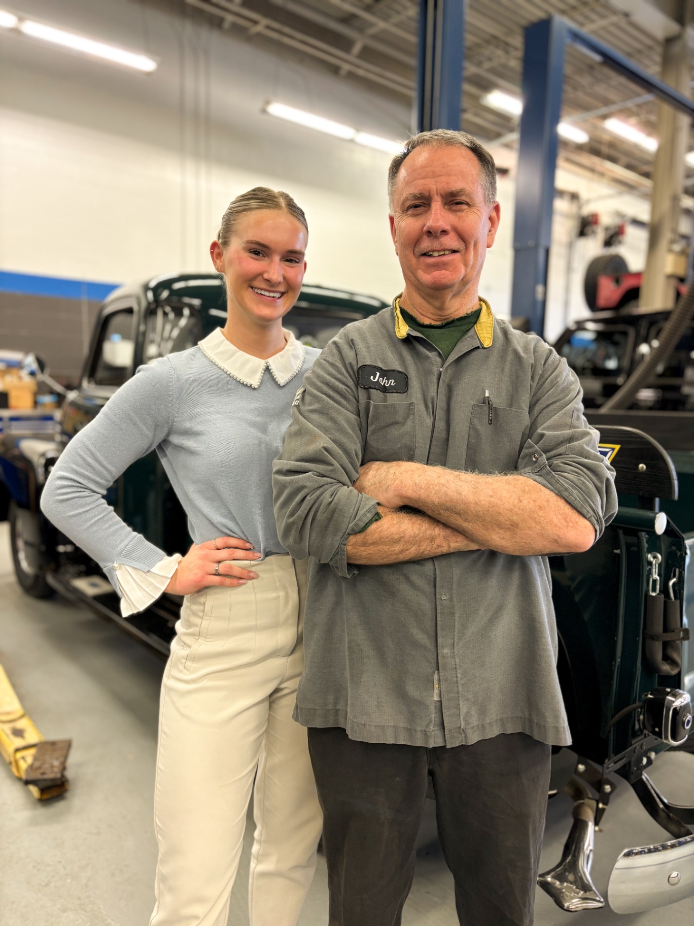 Patriot service advisor and veteran technician John in front of a vintage green pickup truck
