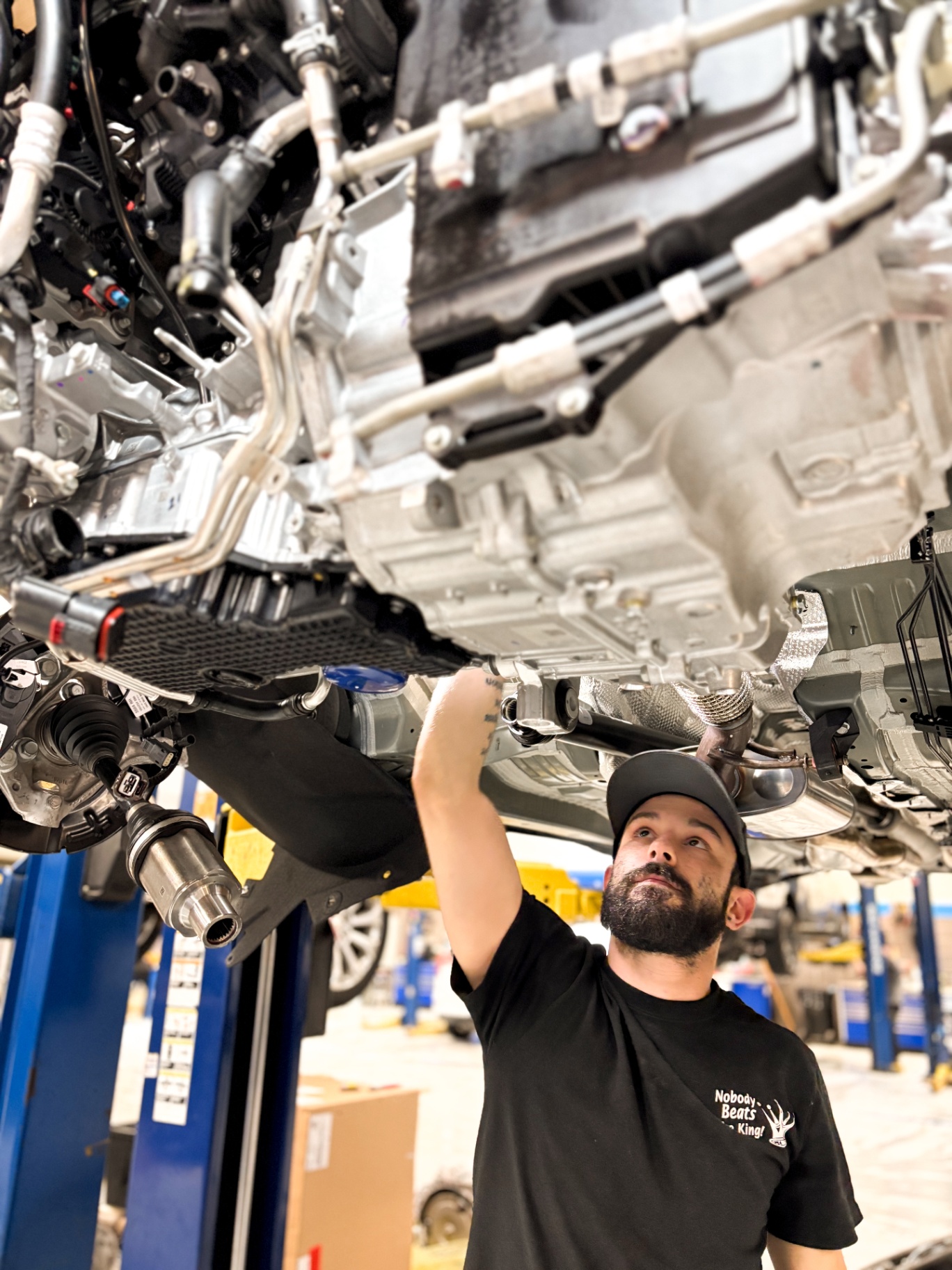 Patriot technician working on the underbody of a lifted vehicle